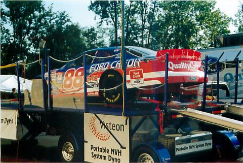 1971 Ford Ranchero - Race car with 'Ford Credit' and 'Quality Care' branding is loaded onto a trailer.