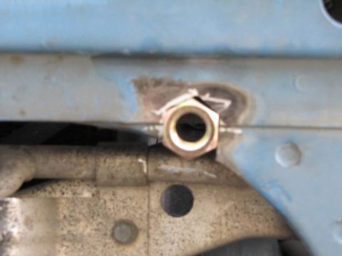 1993 Ford F-250 - A nut has been welded onto a vehicle frame, likely for a component attachment.
