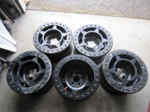 1996 Ford Bronco - Set of five black off-road wheels, a star pattern and beadlock rings, suitable for various trucks and SUVs.