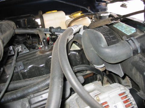 2002 Jeep Wrangler - Close-up view of a Jeep engine bay, showing various components and hoses.