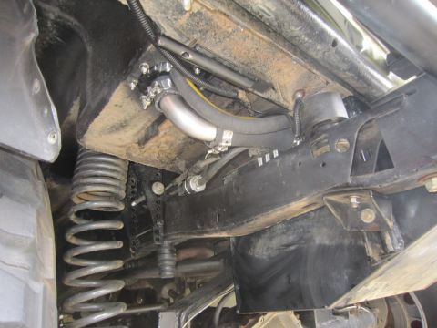 1974 Ford Bronco - Close-up view of the undercarriage, focusing on suspension and fuel system parts.