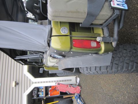 1974 Ford Bronco - Off-road vehicle rear with jerrycan and license plate.