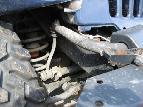2002 Jeep Wrangler - This photo shows the front suspension system of a Jeep Wrangler, including the tire and coil spring.