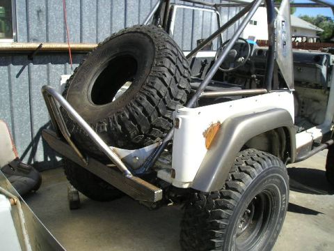 1987 Suzuki Samurai - This Suzuki Samurai features a custom roll cage and a rear-mounted spare tire carrier.