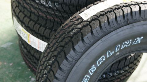 1978 Ford Bronco - Several tires are stacked, with the brand name 'BERLINE' clearly visible on the side of the closest tire.