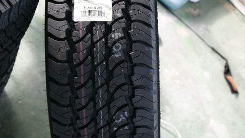 1978 Ford Bronco - A tire with a label showing product information is shown in detail.