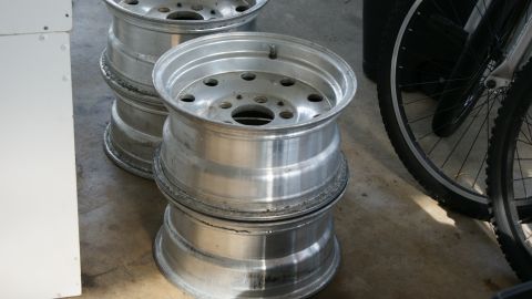 1978 Ford Bronco - A stack of aluminum wheels is visible next to bicycle tires and a white cabinet.