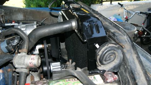 1978 Ford Bronco - The engine bay of a vehicle is shown with a focus on the radiator and surrounding components.
