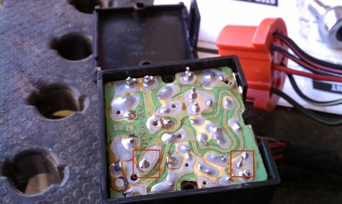 1990 Ford Bronco - Close-up of a vehicle's electronic component, showing a circuit board and wiring harness.