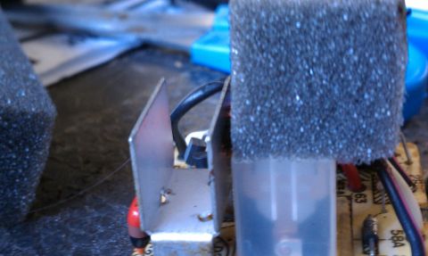1990 Ford Bronco - Electronic component with heatsink and foam padding, wires connected to a circuit board.