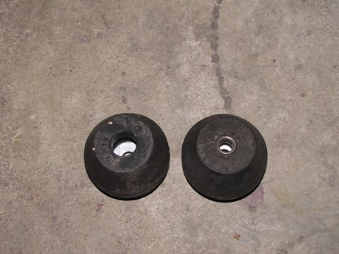 1995 Ford Bronco - Two black rubber mounts are shown on a concrete surface. The registry label indicates a 1995 Ford Bronco, but this photo shows only parts.