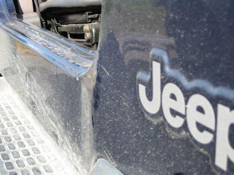 2002 Jeep Wrangler - 2002 Jeep Wrangler door emblem and interior detail. The 'Jeep' logo is clearly visible.