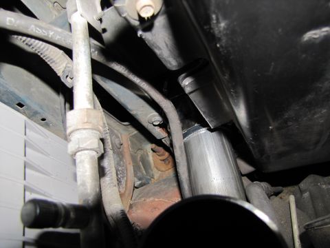 1993 Ford F-250 - Installation of a new exhaust pipe section, with visible plumbing and mounting hardware.