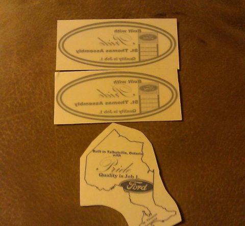 2000 Mercury Grand Marquis - Decals and emblems related to Ford manufacturing and branding are displayed on a textured surface.