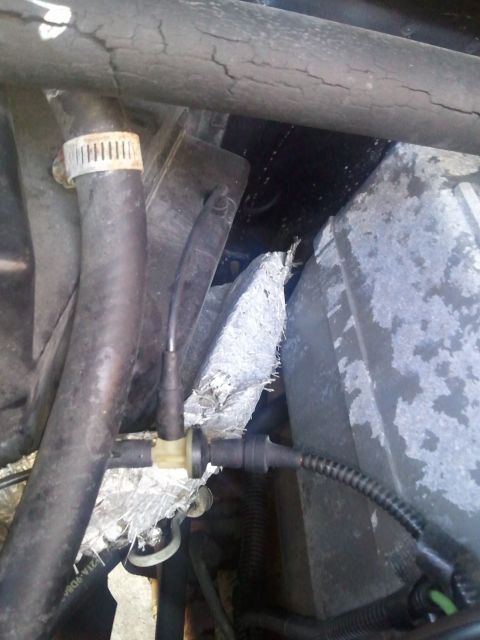 1994 Ford Bronco - Close-up view of engine bay components, including hoses and insulation.
