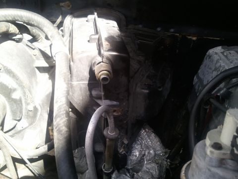 1994 Ford Bronco - Close-up view of the air conditioning system components within a vehicle's engine bay.