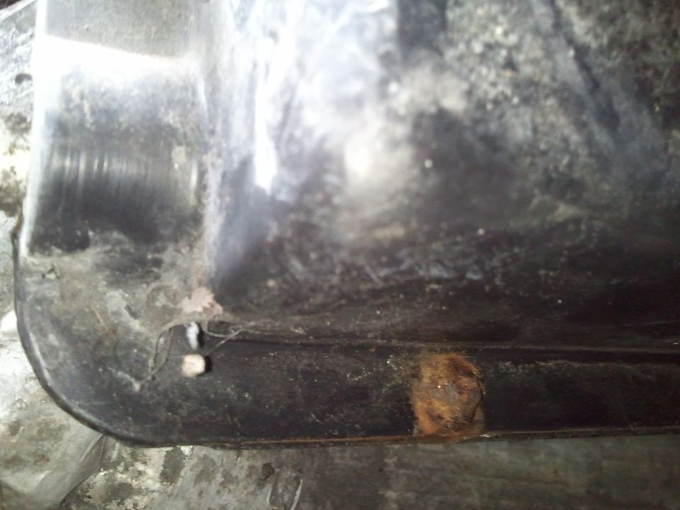 Close-up of a rusted metal part with some dirt and grime