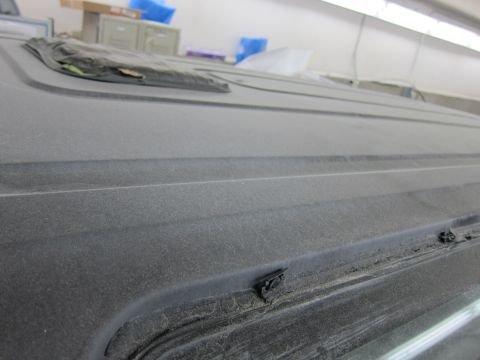 1987 Dodge 1500 - The top of a vehicle, covered in dust, shows some trim and clips along the edge.
