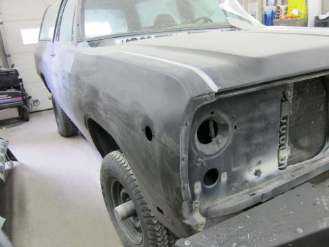 1987 Dodge 1500 - This SUV is undergoing bodywork, with its front end disassembled and primer applied.