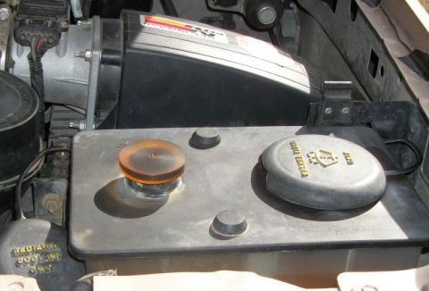 1996 Ford Bronco - Close-up view of the engine bay, showing a K&N performance air filter and the coolant reservoir.