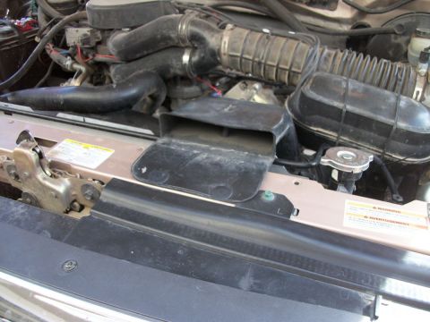 1996 Ford Bronco - Close-up view of an engine bay, focusing on air intake components and the radiator.