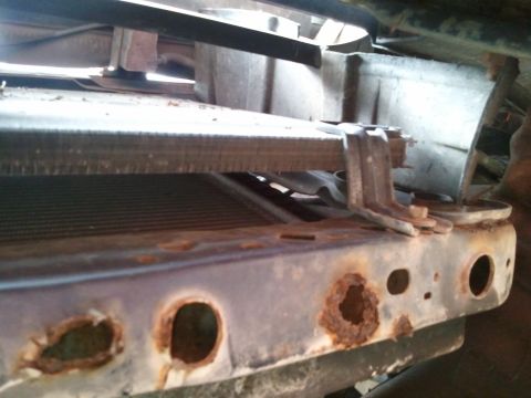 1994 Ford Bronco - The front radiator support shows significant rust damage with holes visible.