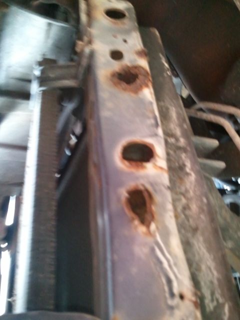 1994 Ford Bronco - This image shows a heavily corroded metal frame, with no clear year identification visible.