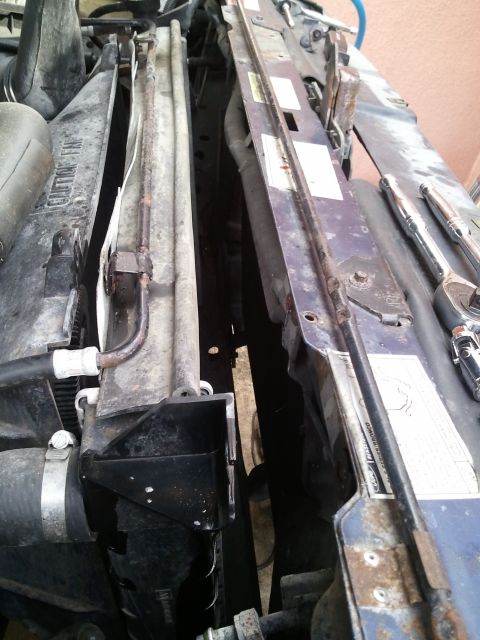 1994 Ford Bronco - Radiator and fan assembly with tools nearby, likely for repair or maintenance.