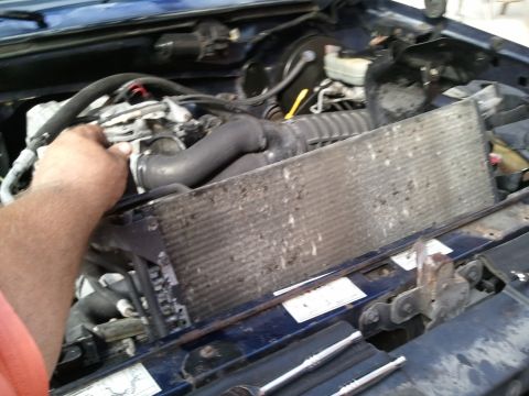 1994 Ford Bronco - Close-up view of a vehicle's engine bay, focusing on the radiator and associated hoses.