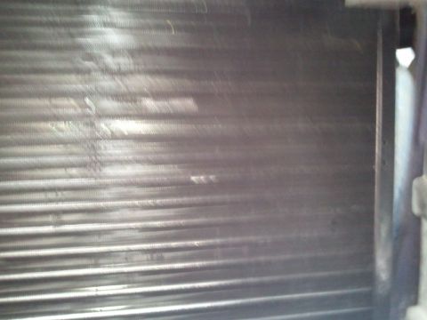 1994 Ford Bronco - The image shows a close-up view of the fins on an air conditioning condenser unit, with some dirt and debris visible.