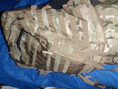 1991 Ford Bronco - A close-up view of a camouflage backpack with numerous straps and buckles.
