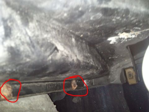 1994 Ford Bronco - Close-up view of rust spots on the underside of a vehicle, possibly related to the AC system.
