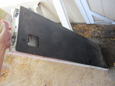 1987 Suzuki Samurai - This is a car door panel, likely for a Suzuki Samurai, with the black insulation removed.