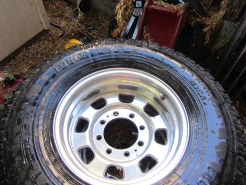1987 Suzuki Samurai - A close-up view of a tire and a shiny chrome rim, likely for a truck or SUV.