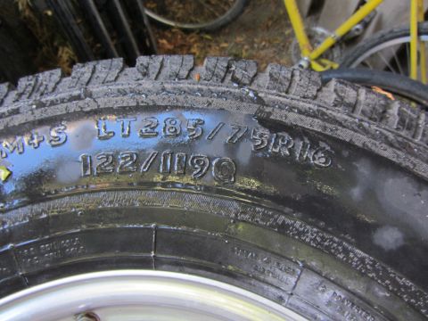 1987 Suzuki Samurai - Close-up of a tire's sidewall displaying its size and load rating information.