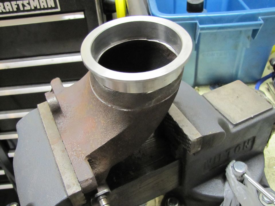 Turbo elbow pipe clamped in a Wilton vise