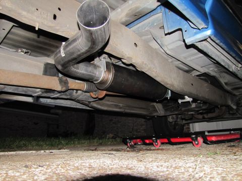 1993 Ford F-250 - Custom exhaust system installed on a vehicle, showing the muffler and piping.