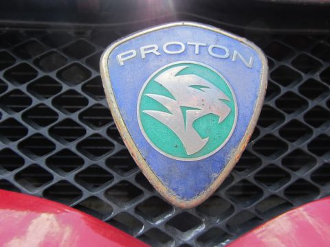 1968 Ford Mustang - Close-up of a Proton badge affixed to a vehicle's front grille.