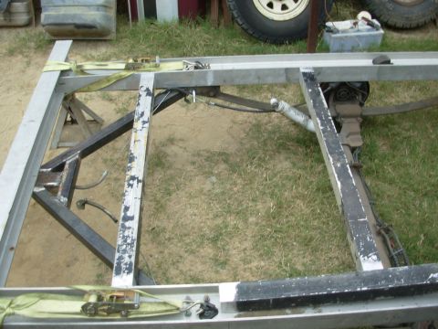 2004 Land Rover Land Rover - 27.5" should be just enough room between the front 2 floor joists for a hidden spare tire.