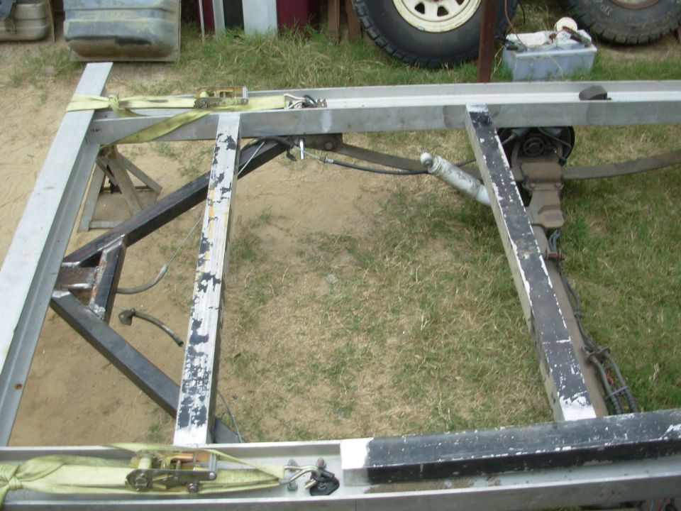 27.5" should be just enough room between the front 2 floor joists for a hidden spare tire.