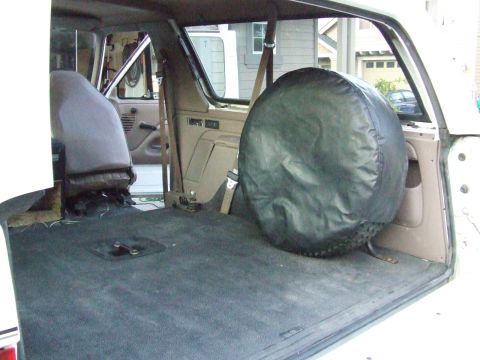 1996 Ford Bronco - Interior view of a 1996 Ford Bronco, highlighting the cargo space and spare tire mount.