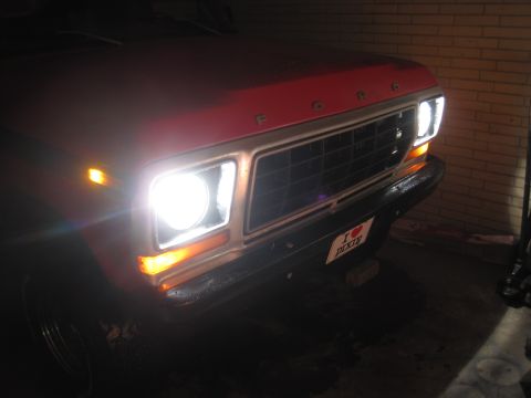 1979 Ford Bronco - The front grille and headlights of a red 1979 Ford Bronco are visible, along with a "I LOVE DIXIE" license plate.