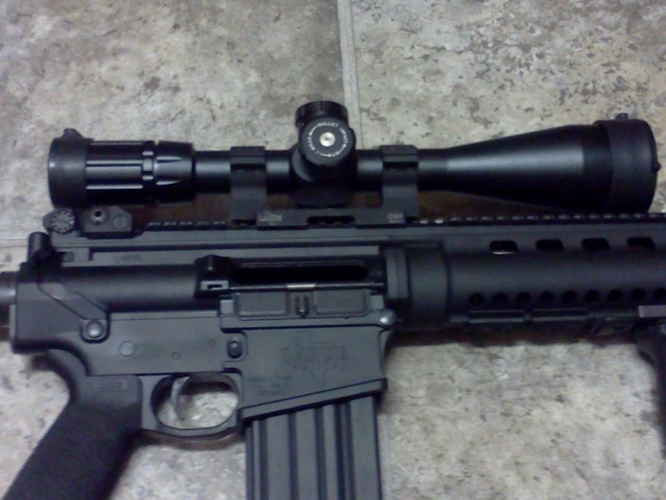 Close-up of an assault rifle with a scope mounted on top
