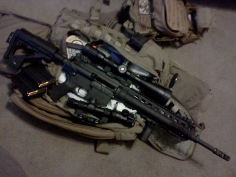 1996 Ford Bronco - An assault rifle with scopes and magazines is placed on tactical gear.
