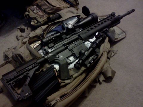1996 Ford Bronco - An assault rifle with a scope and loaded magazine rests on a tactical bag.