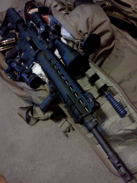 1996 Ford Bronco - Tactical rifle with scope and bipod laid out on a bag.