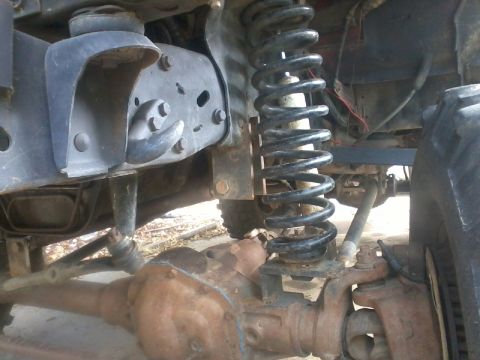 1986 Ford Bronco - This photo shows the undercarriage of a vehicle, focusing on the front suspension and axle components.