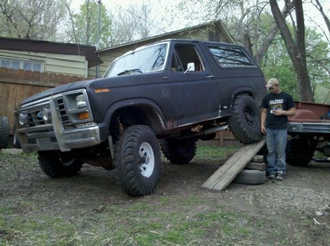 1986 Ford Bronco - This lifted SUV, likely from the 1980s, is positioned on a makeshift ramp.