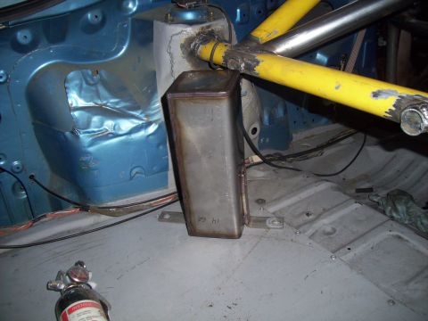 1995 Ford Probe - Modified car interior shows blue metal, yellow roll cage, and a metal box with a fire extinguisher.