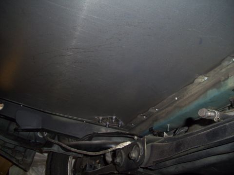 1995 Ford Probe - Underside view of a vehicle, showing suspension, exhaust, and underbody paneling. The registry claims 1995 Ford Probe, but this is unconfir…